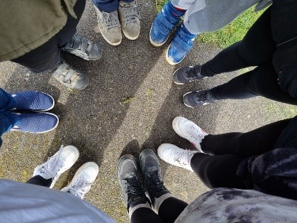 Group of young people's shoes all standing in a circle