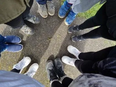 Group of young people's shoes all standing in a circle