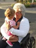 Child being held by grandparent