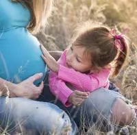 Image shows pregnant woman and child