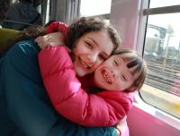Children on train, hugging
