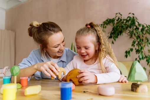 Mum and daughter playing with wooden toys