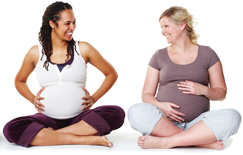 Two Pregnant women sitting with legs crossed
