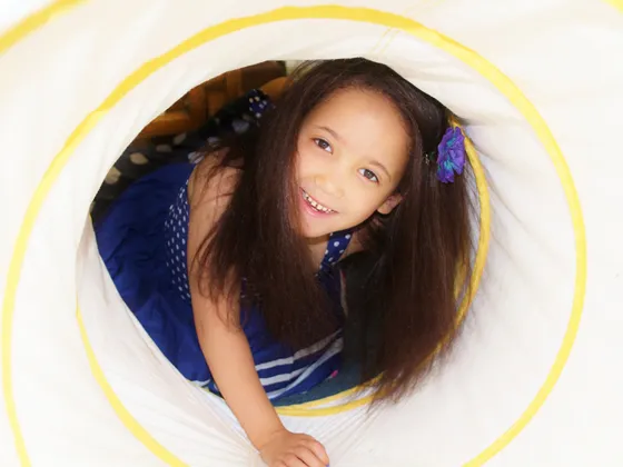 Girl in a play tunnel
