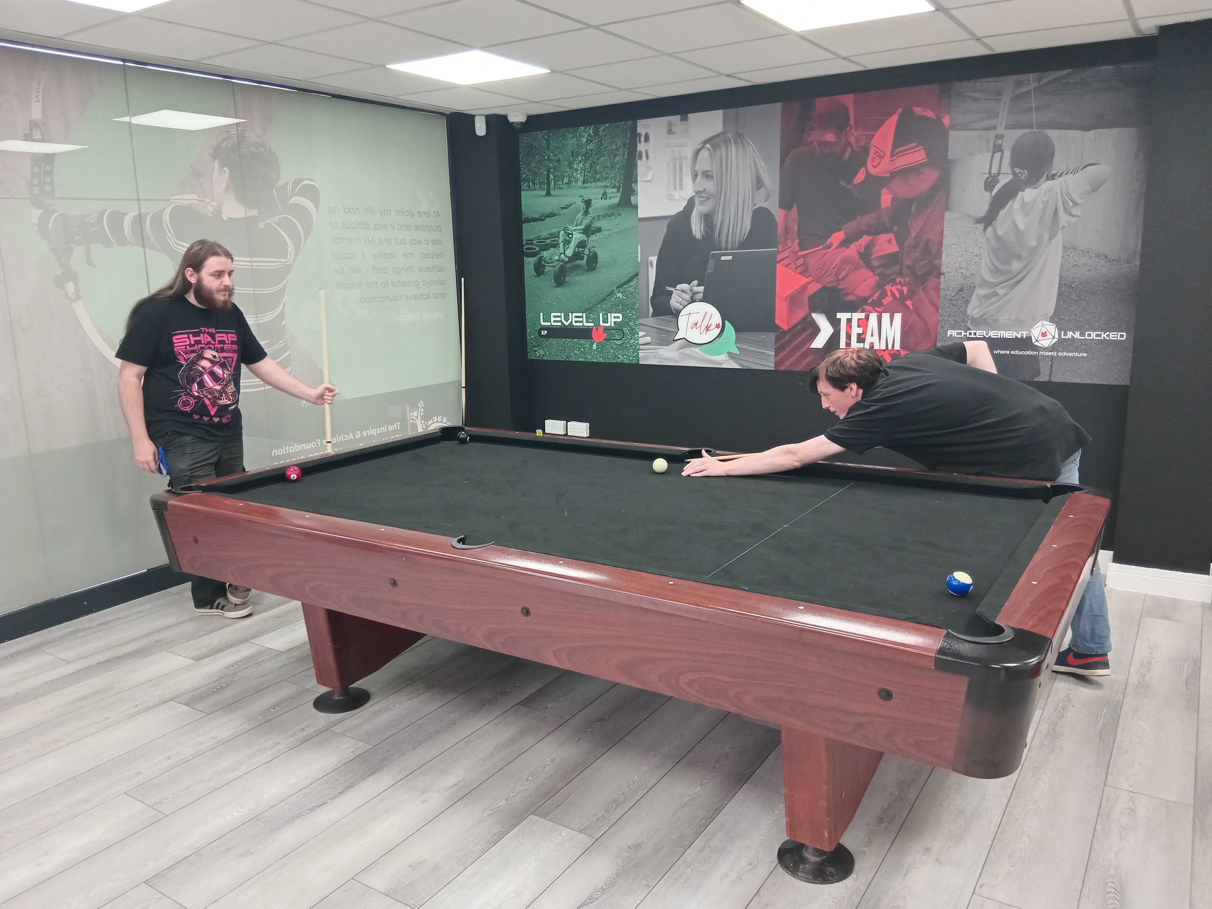 young people playing pool