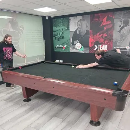 young people playing pool