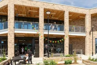 YMCA outside the cafe. Balconies and big windows create an inviting space.