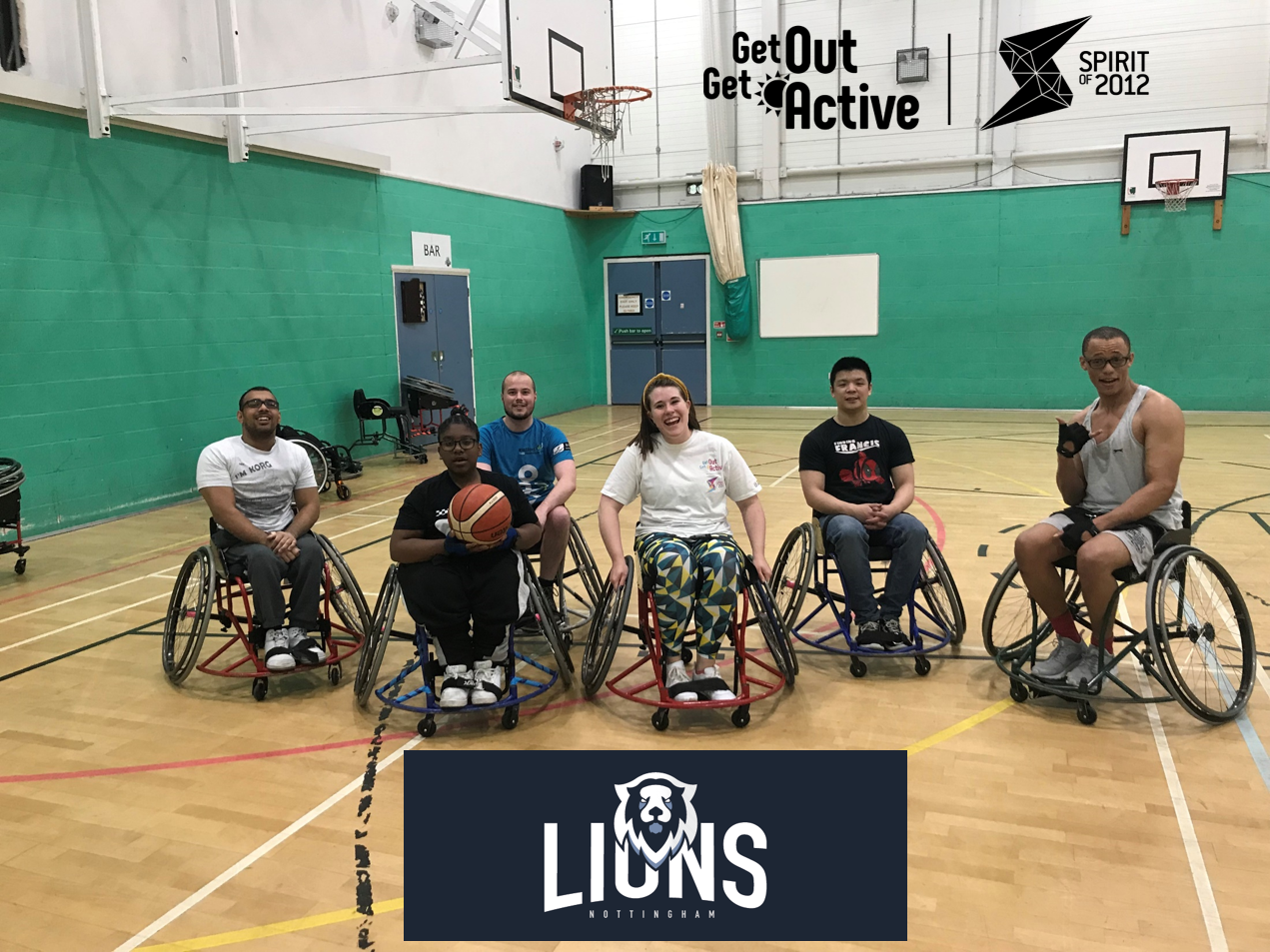 Group of people in wheelchairs in sports hall