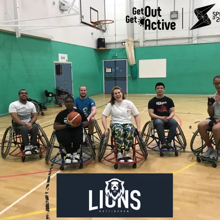 Group of people in wheelchairs in sports hall