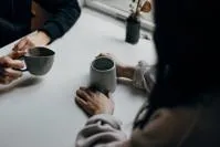 Two people sitting at table with coffee
