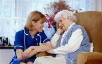 nurse supporting elderly person