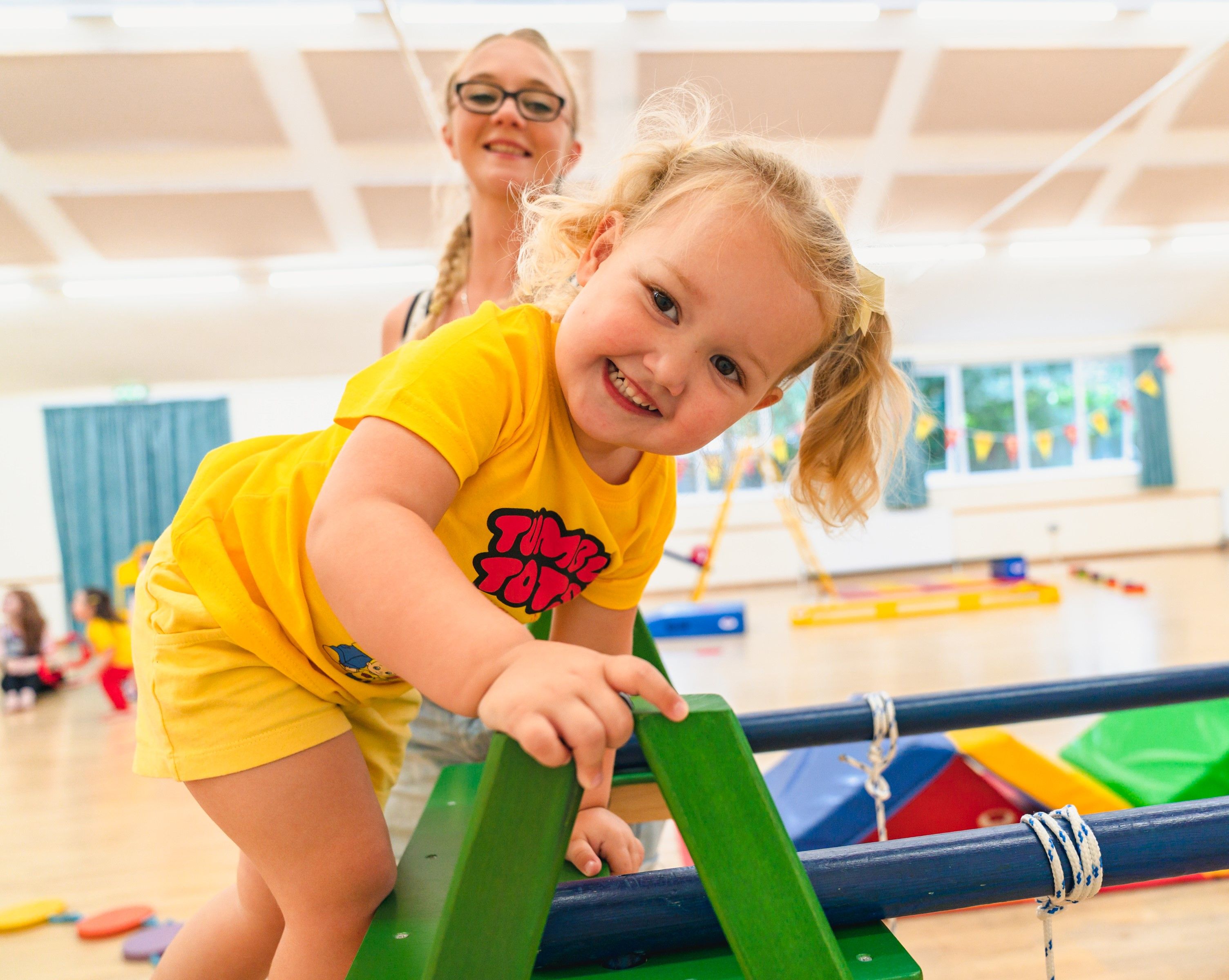 Girl on a wooden climbing frame