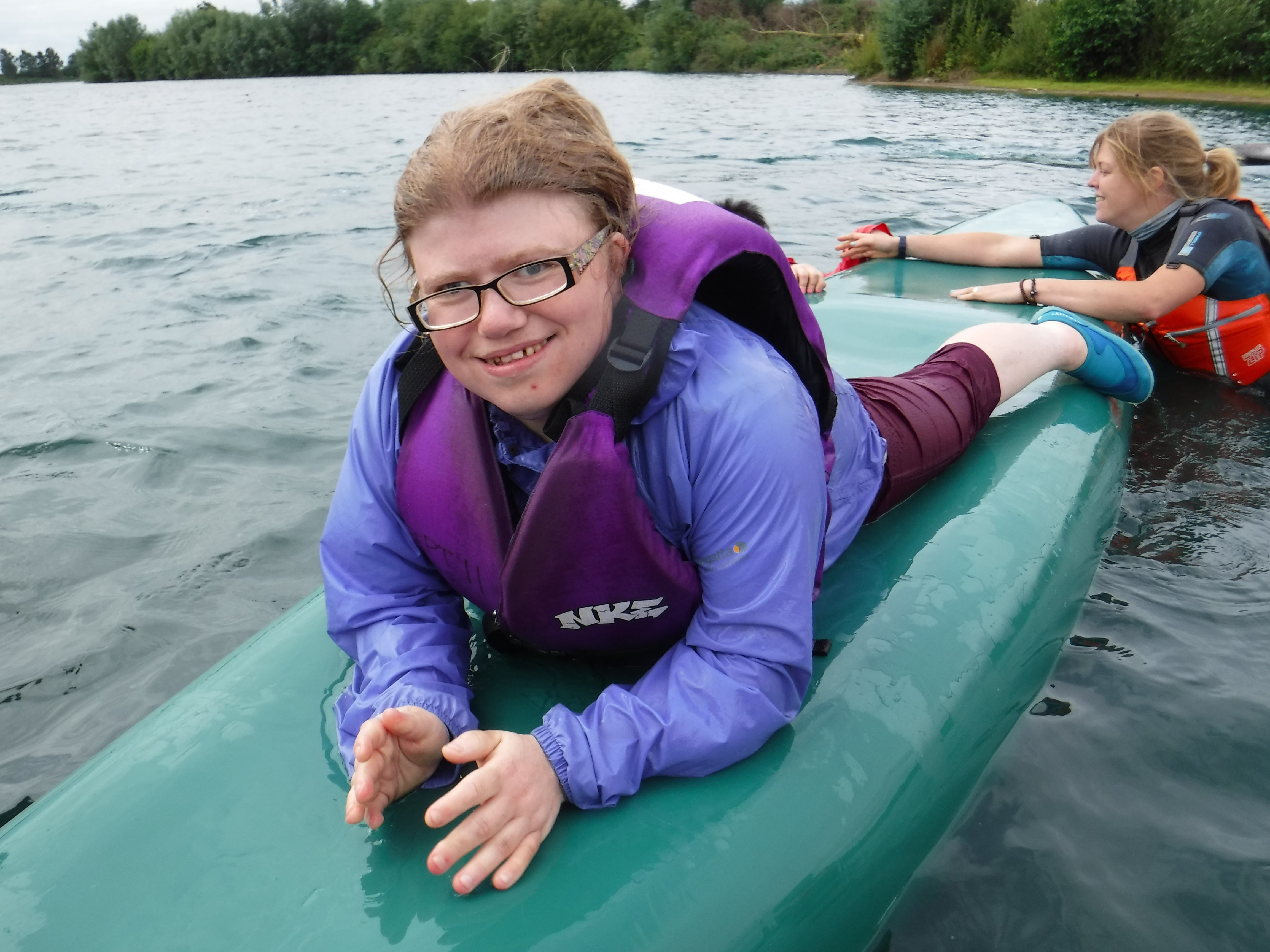 Woman lying on a paddle board