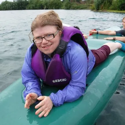 Woman lying on a paddle board