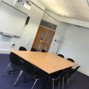 Downstairs Meeting Room
Large wooden table with surrounding chairs