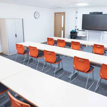 Stapleford Room 2
Bright and spacious with orange chairs and white desks. Large monitor on the far wall.