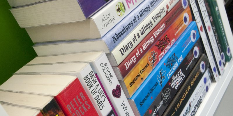 Image of multicoloured books stacked together.