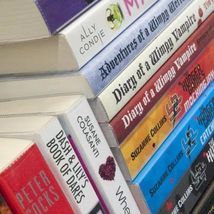 Image of multicoloured books stacked together.